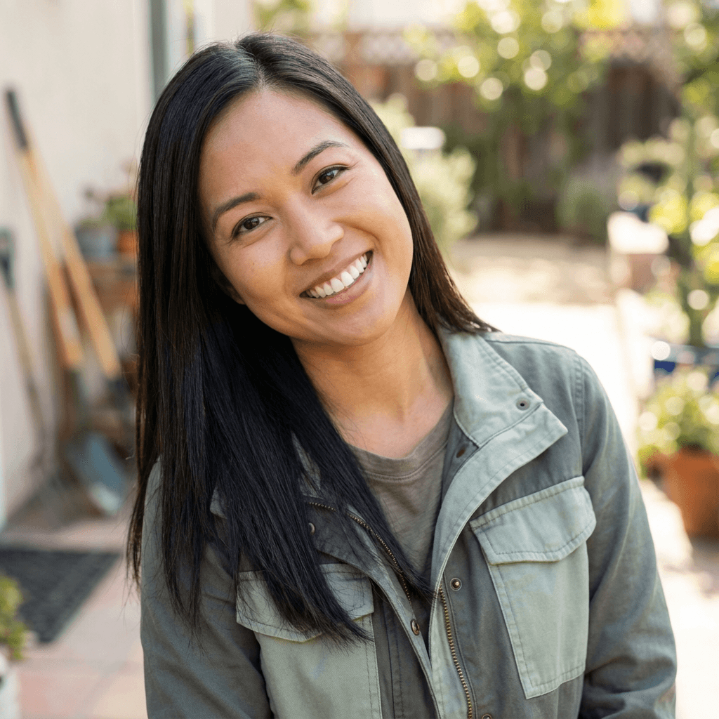 Warm portrait of a female family caregiver in her late 30s smiling softly